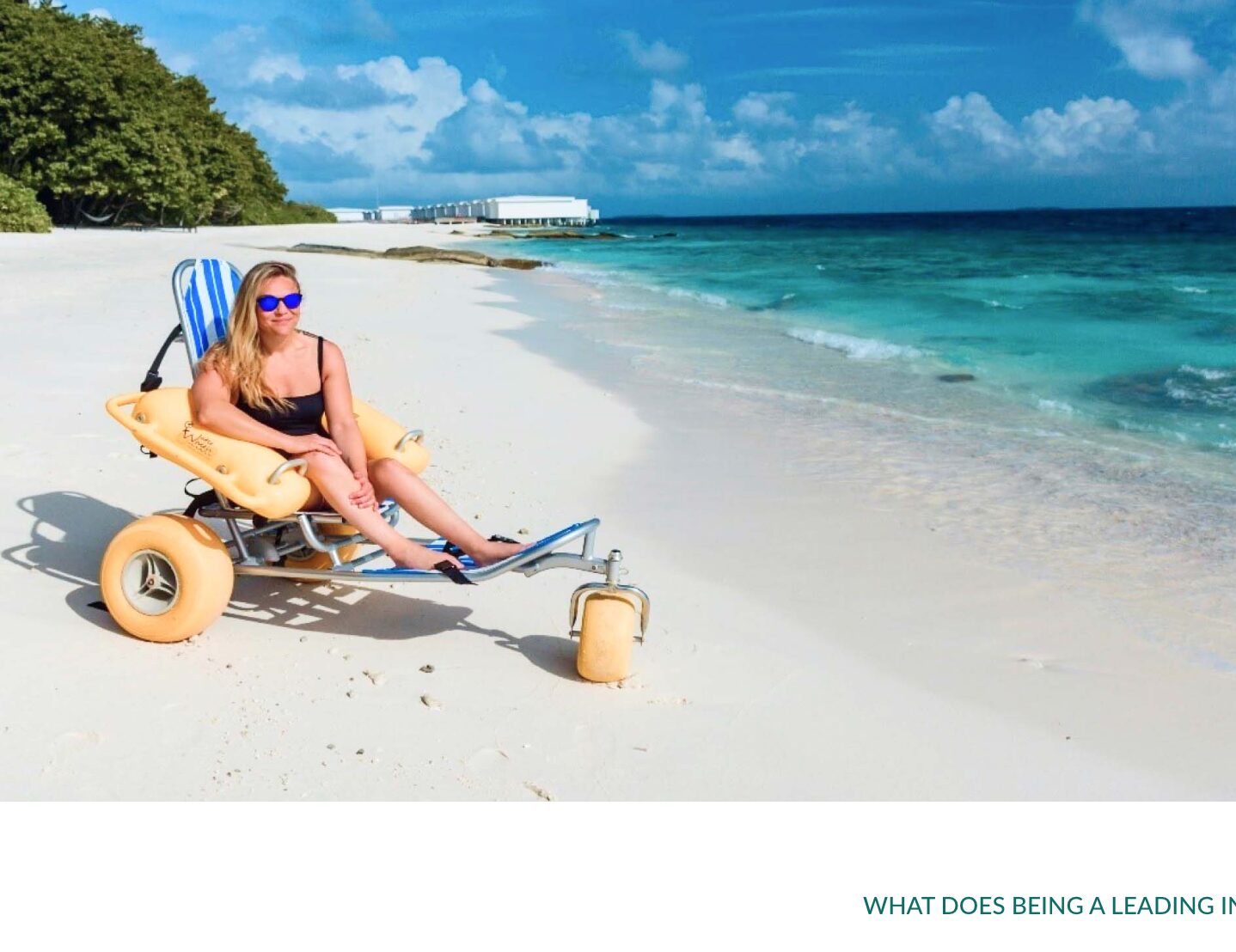 A woman in her bathing costume in a beach wheelcahir at the shorelune on the beach